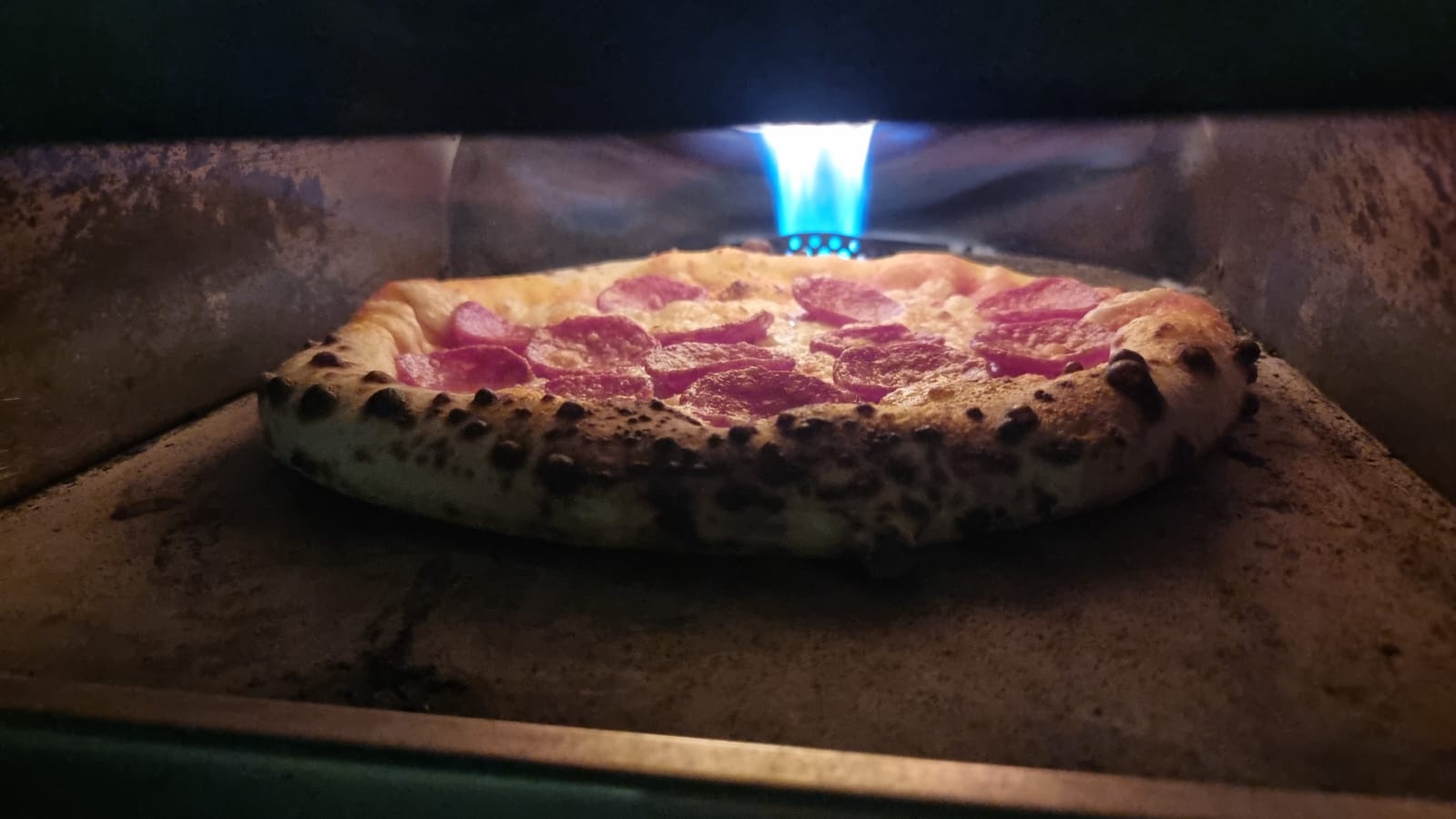 Artisan pizza being prepared with traditional techniques